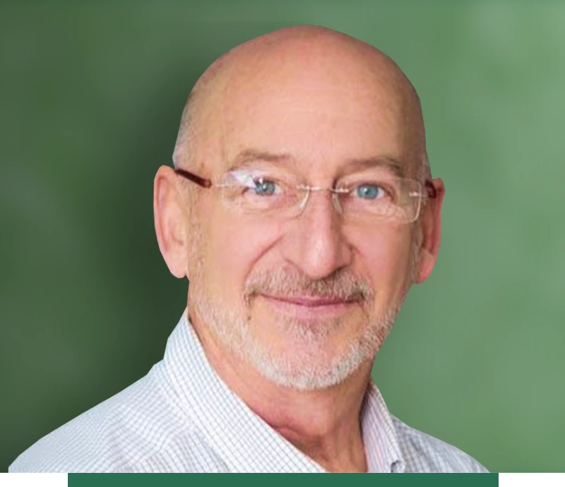 A man with glasses in front of green background