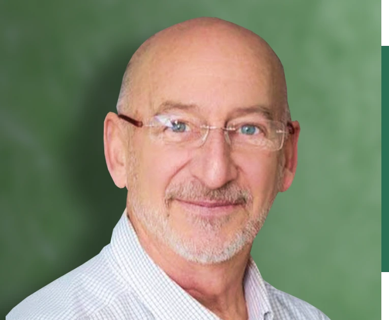 A man with glasses in front of green background
