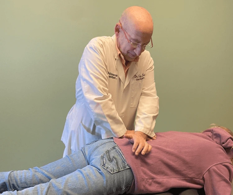 Chiropractor adjusting a patient lying face down