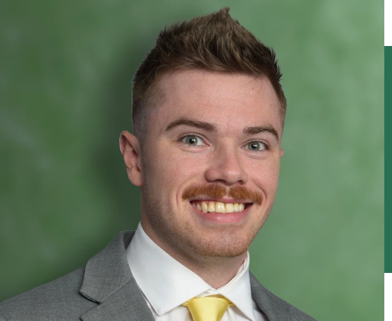 Smiling man in front of green background