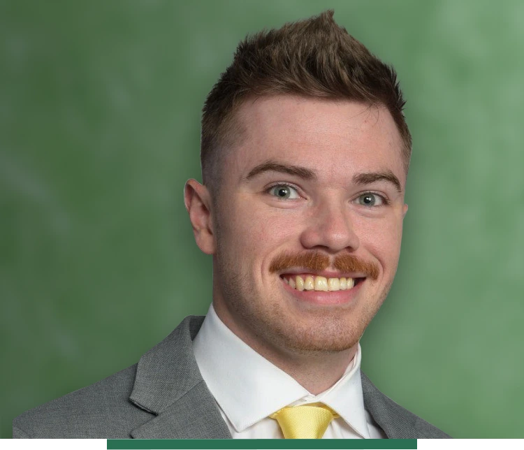 A man with smile in front of green background