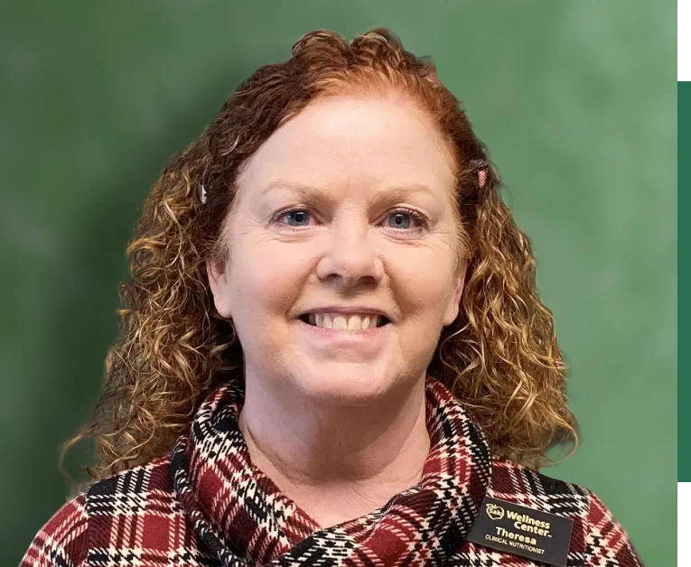 A woman with smile in front of green background