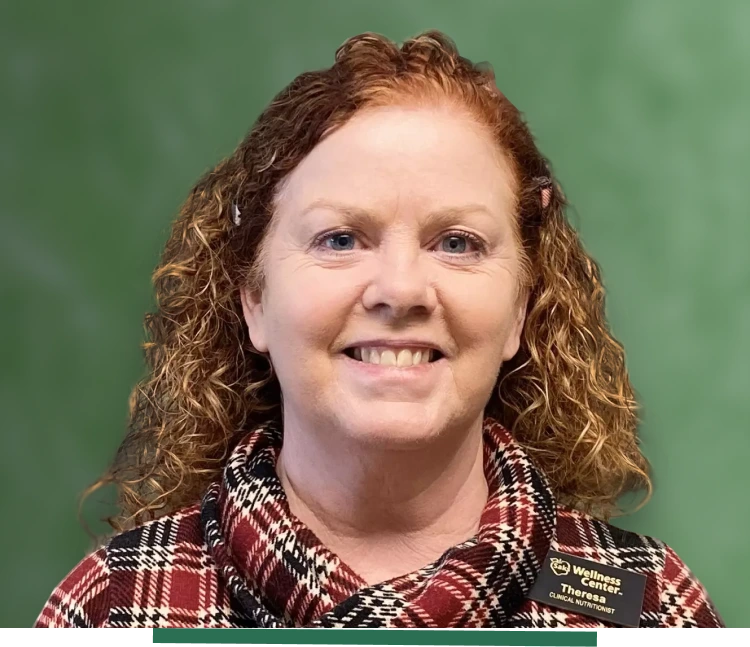 A woman with curly hair in front of green background